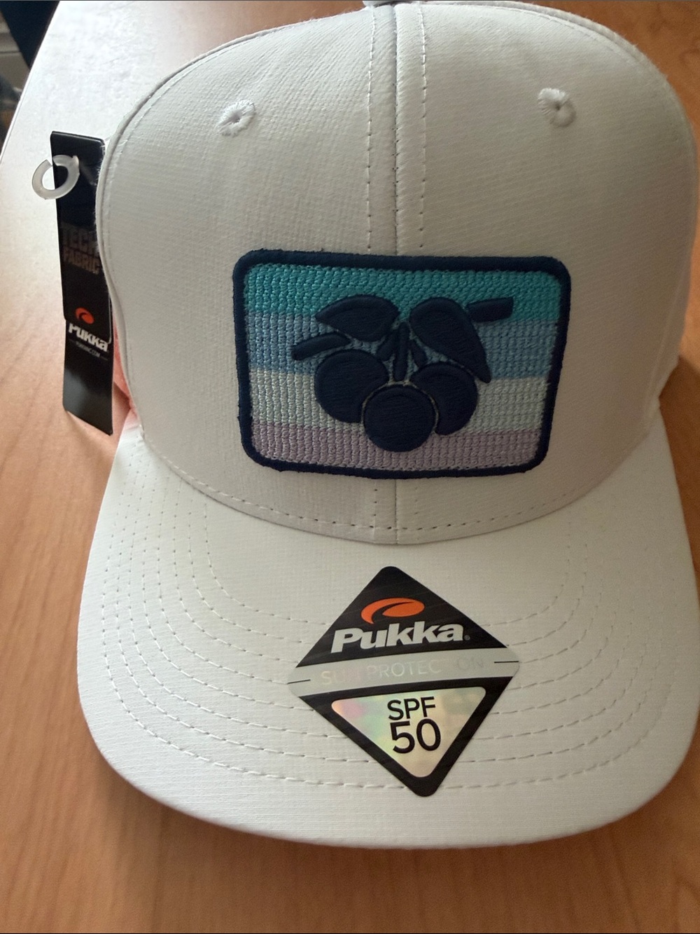 Pukka White Men's Trucker Hat with Blue Cherry Patch